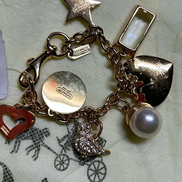Coach Gold-Tone Charm Bracelet with Pearl, Crystal Baguette & Pave Heart - Picture 2 of 3